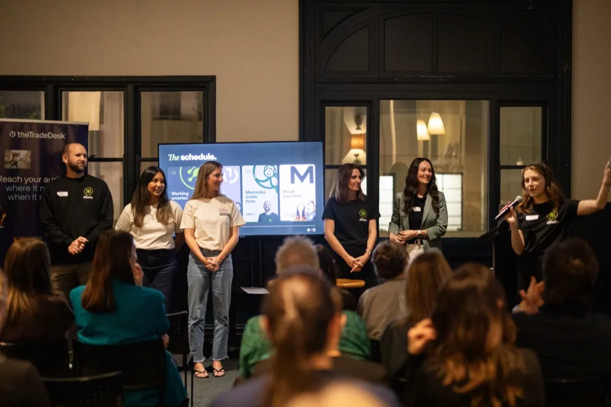 The speaker line-up on stage at the Dilate x The Trade Desk event, with the schedule on screen